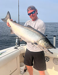 Captain Mark Ledden holding a very large salmon from Lake Ontario